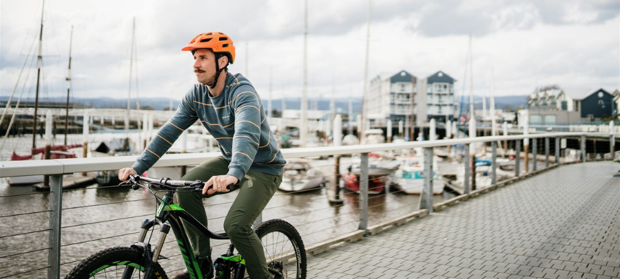 Image of a middle aged man on a bicycle at the Seaport, Launceston. Image credit: Launceston Place Brand - Nick Hanson