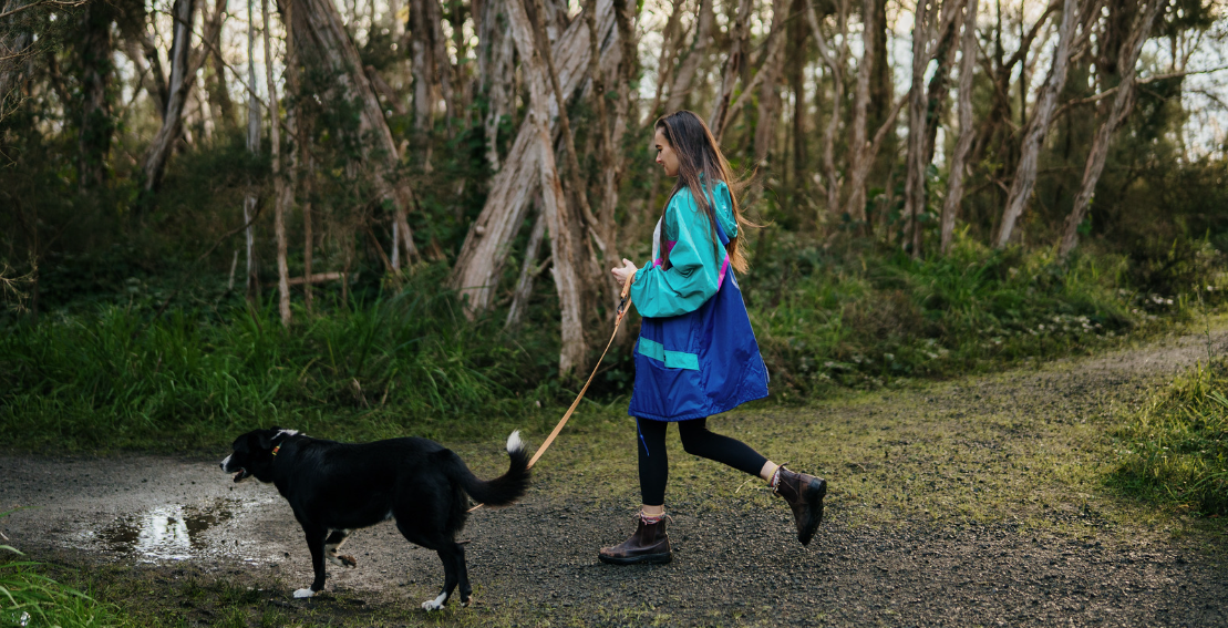 A woman walking her dog on a Launceston walking trail.