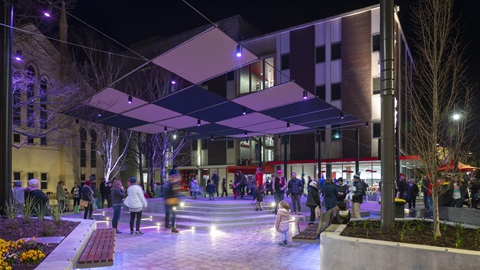 Civic Square, Launceston Night Market. Entrance to LINC, dark sky, purple lighting, patrons