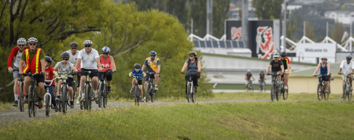 community members on a group bike ride across Launceston