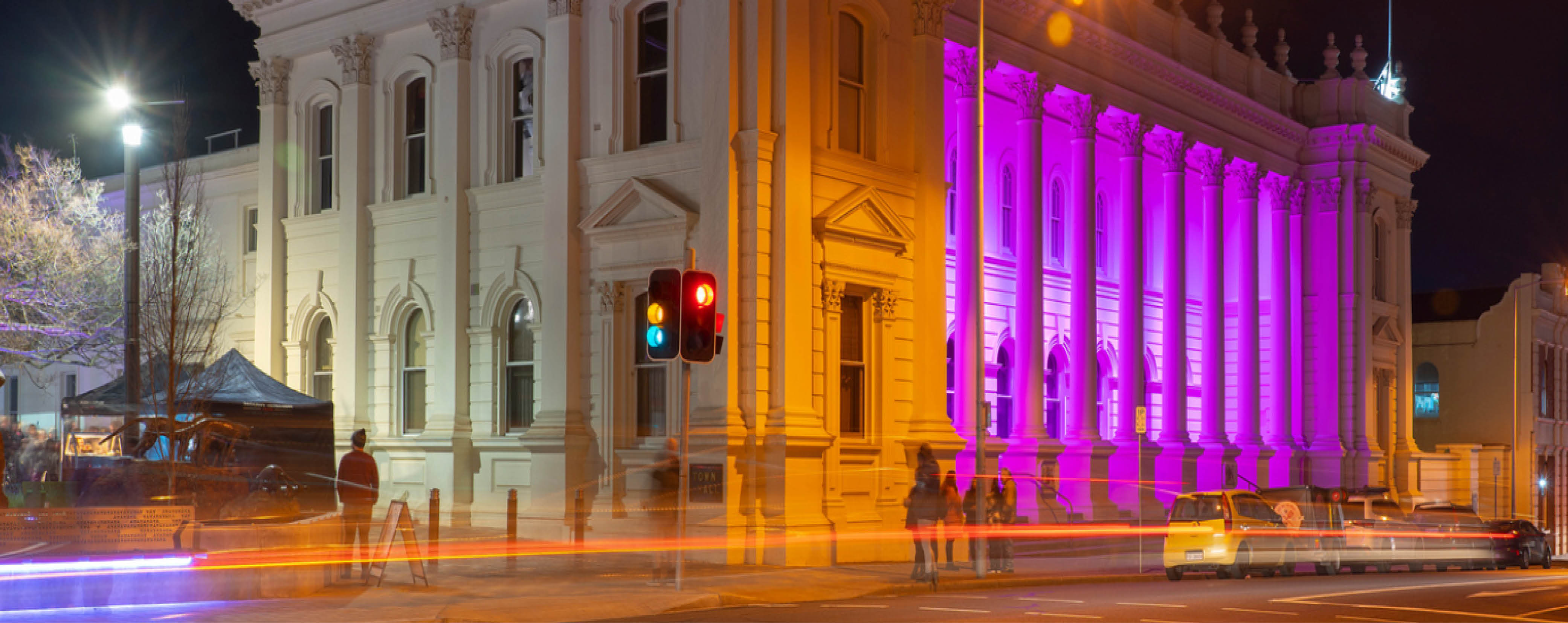 Illuminating town hall at night time with colored lighting